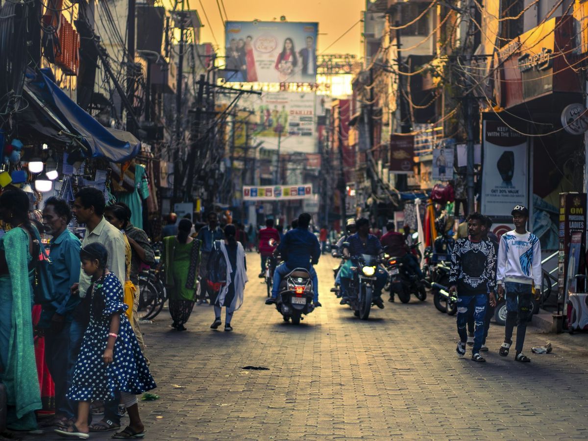 A busy market street in India at dusk