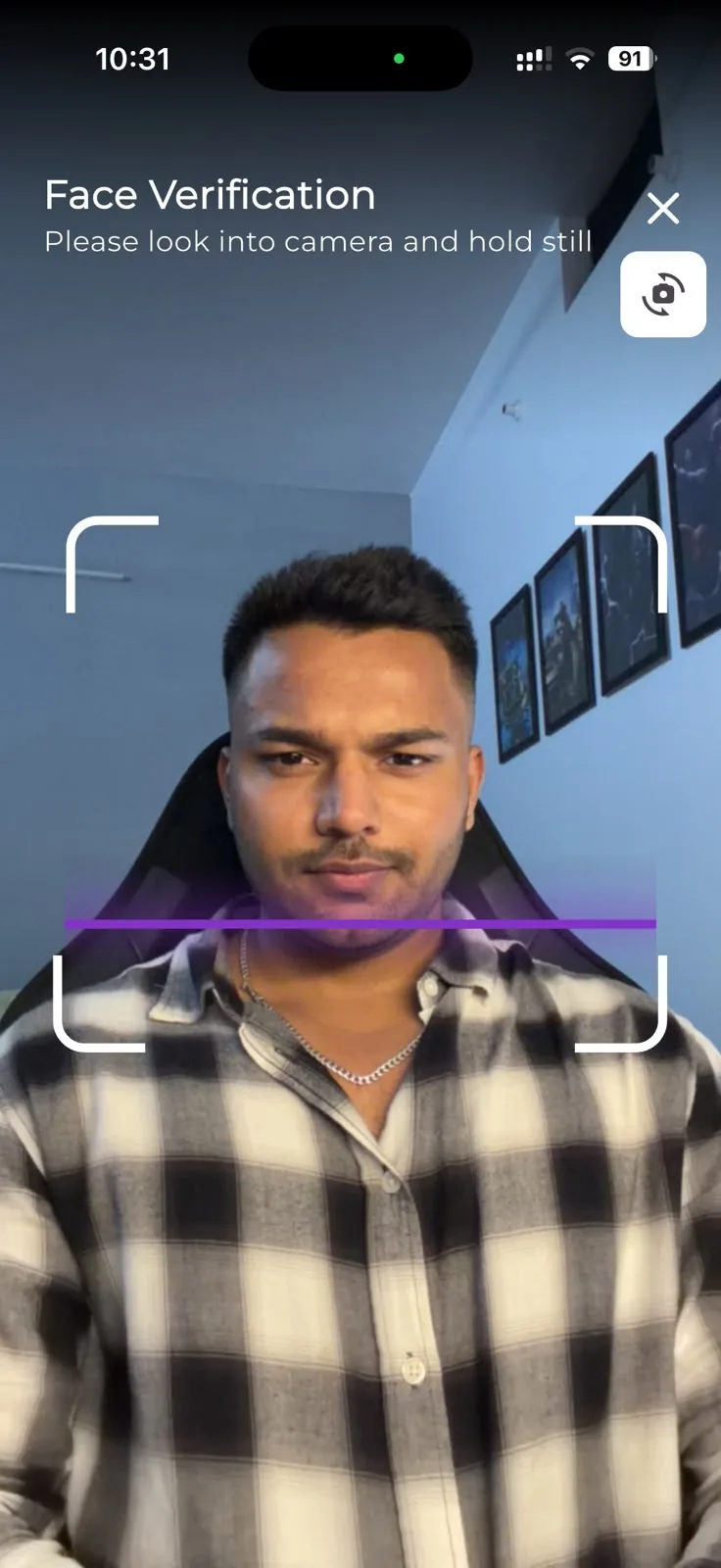 VerifyU face verification camera screen asking the person to look into the camera and hold still