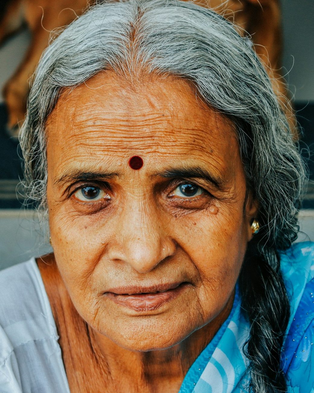 An older woman looking calmly at the camera